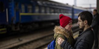 Tearful goodbyes at Kyiv train station as women and children leave for safety